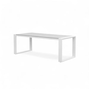 Side view of the Linz outdoor table, showing the minimal aluminum frame and the matte glass surface.