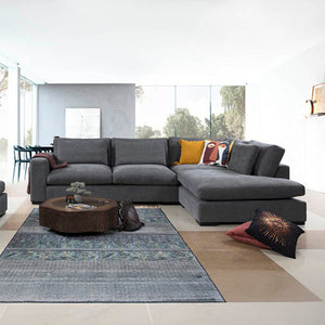 Modern Lagun corner sofa in a dark grey colour, with plush cushions and wide arms. / Grey