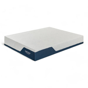 Ανατομικό στρώμα memory foam με λευκή επιφάνεια και πλαϊνά σε σκούρο μπλε χρώμα αντίθεσης, παρέχοντας μέτρια προς σκληρή στήριξη.