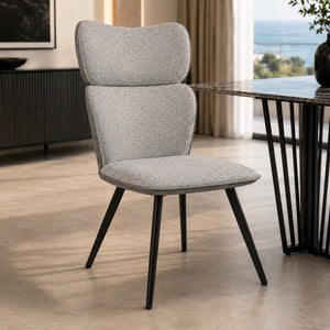 VITRA chair in light grey fabric with a high back and black legs, placed next to a modern table.