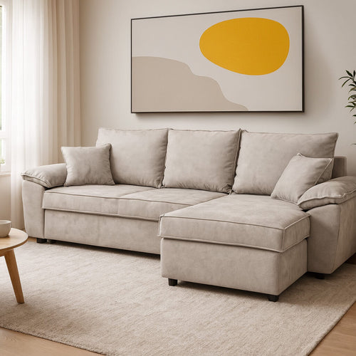 Modern minimalist living room with a greige-sandy L-shaped sofa on a soft ecru rug, a large abstract art landscape with an intense yellow hue on the wall, natural light diffusing through sheer curtains and, at the edge, a wooden side table / Light grey