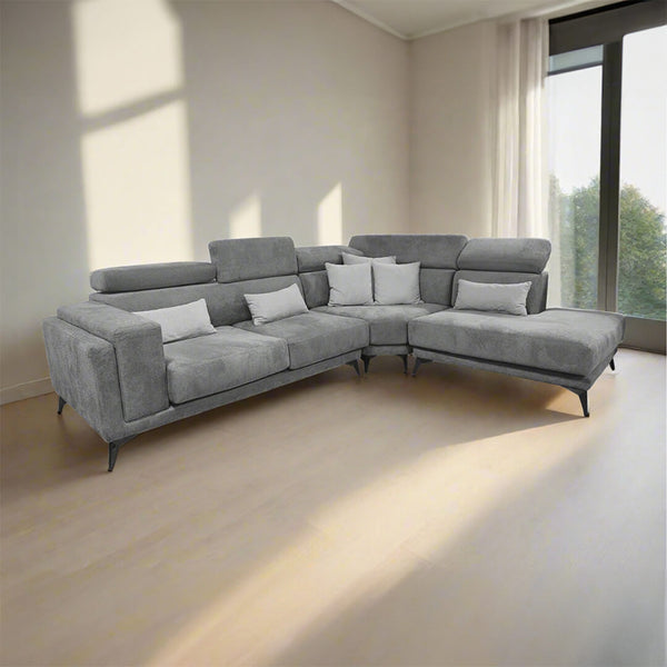 Modern grey corner sofa with adjustable headrest cushions and dark, angled metal legs.
