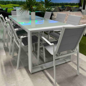 Rectangular Linz aluminum garden table, set for 8 people in a showroom, highlighting its modern design.