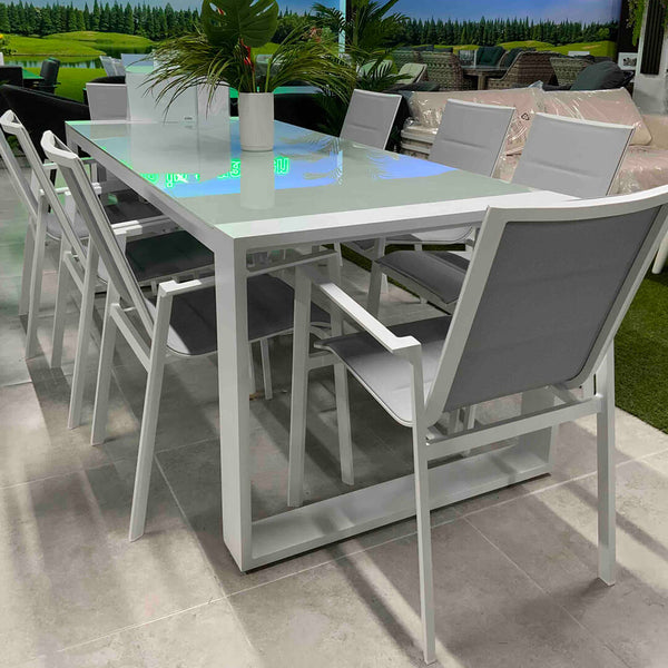 Rectangular Linz aluminum garden table, set for 8 people in a showroom, highlighting its modern design.