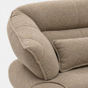 Close-up of the SOFO sofa showing the low-pile mocha brown fabric with a bouclé-like texture and the rounded detail on the arm.